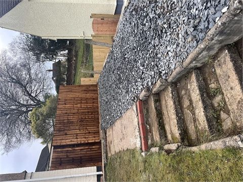 Garden steps beside a gravel bed and timber fencing
