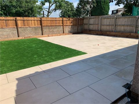 Garden lawn bordered by paving and timber fencing