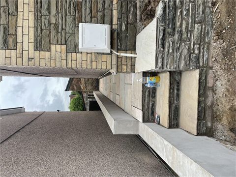 Narrow paved path with steps between two buildings