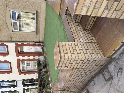 Front garden with green lawn and brick boundary walls