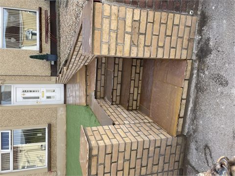 Paved entrance steps between brick boundary walls