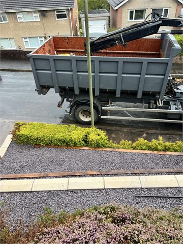Front garden groundworks beside a skip trailer