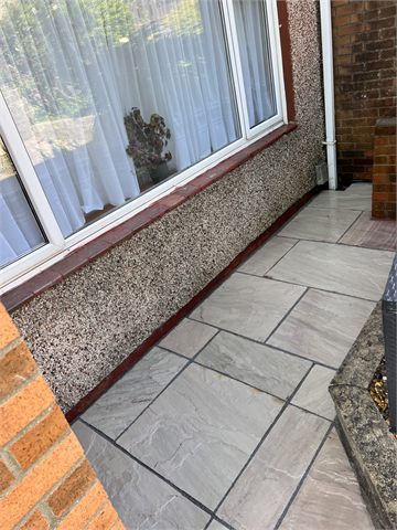 Paved path running beside a house window