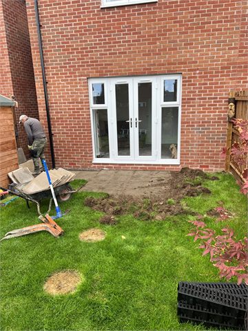 Exposed ground and tools beside rear garden doors
