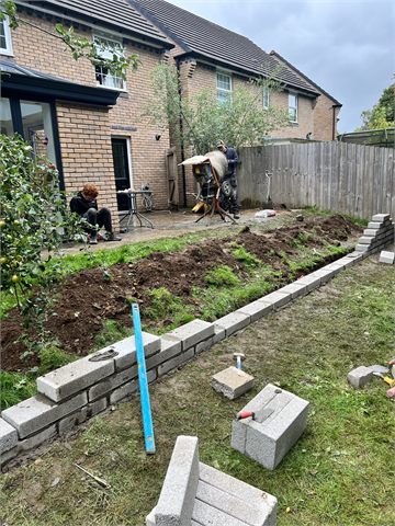 Garden excavation with blockwork and building materials