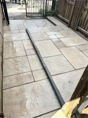Paved side path and steps beside a timber fence